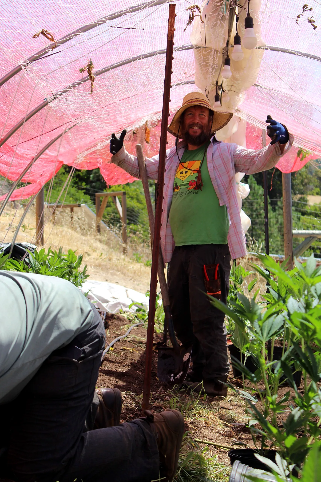 Grower smiling inside the hoophouse